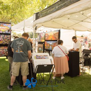 Art in the Park 2021 booth with paintings