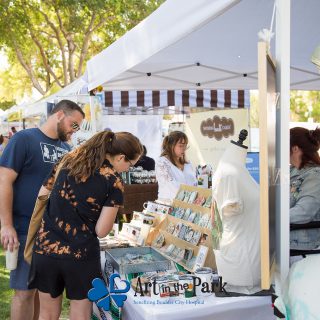 Art in the Park 2021 patrons looking at booth