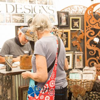 Art in the Park 2021 artist with patron in booth