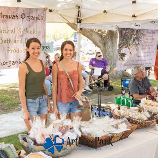 Art in the Park 2021 aravah organics vendors in booth with bath and beauty products